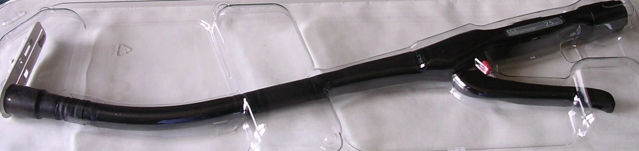 A long curved handheld device has a pistol-style handle and a round distal assembly.