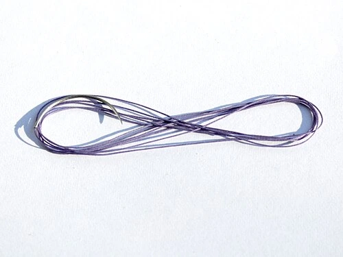 A curved metal needle is attached to a long fine strand looped on a pale background.