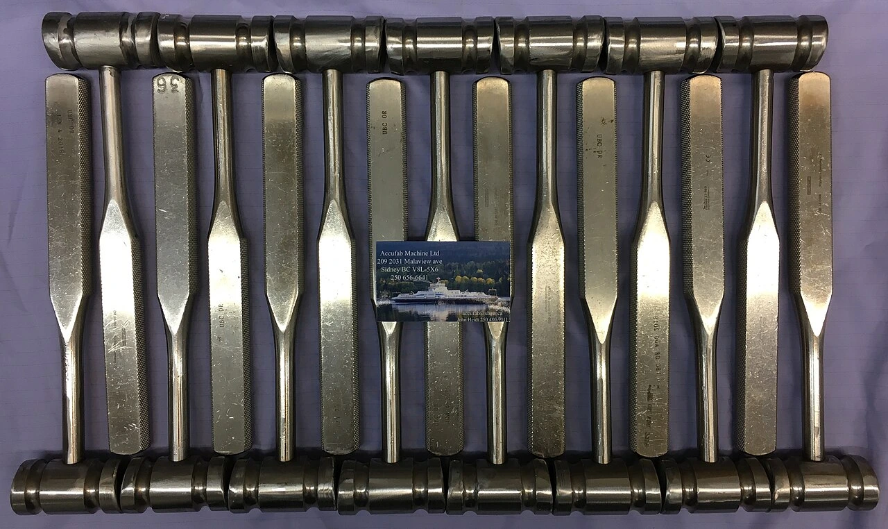Several metal striking tools have broad cylindrical heads and long straight handles.
