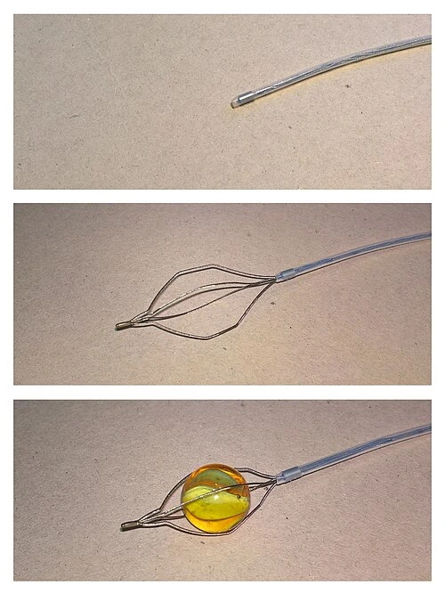 Three views of a thin shaft: its tip closed, opened into a wire basket, and holding a small round object.